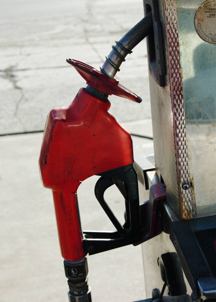 Gas station fuel pump nozzle with splash-back guard.
