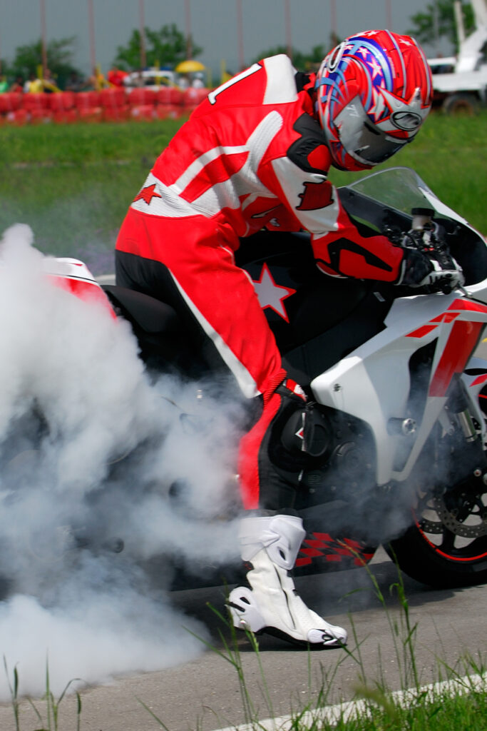 Motorcyclist on smoking bike.