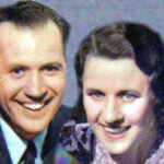 Jim and Mary and Jordan posing for the camera in 1941. The vintage black and white illustration of a couple sitting in a cozy living room. Fibber is holding a newspaper and Molly is knitting. They are both looking at a small dog that is sitting on a rug between them. The room is decorated with a patterned wallpaper, framed pictures, and a vase with flowers on a table in the background."